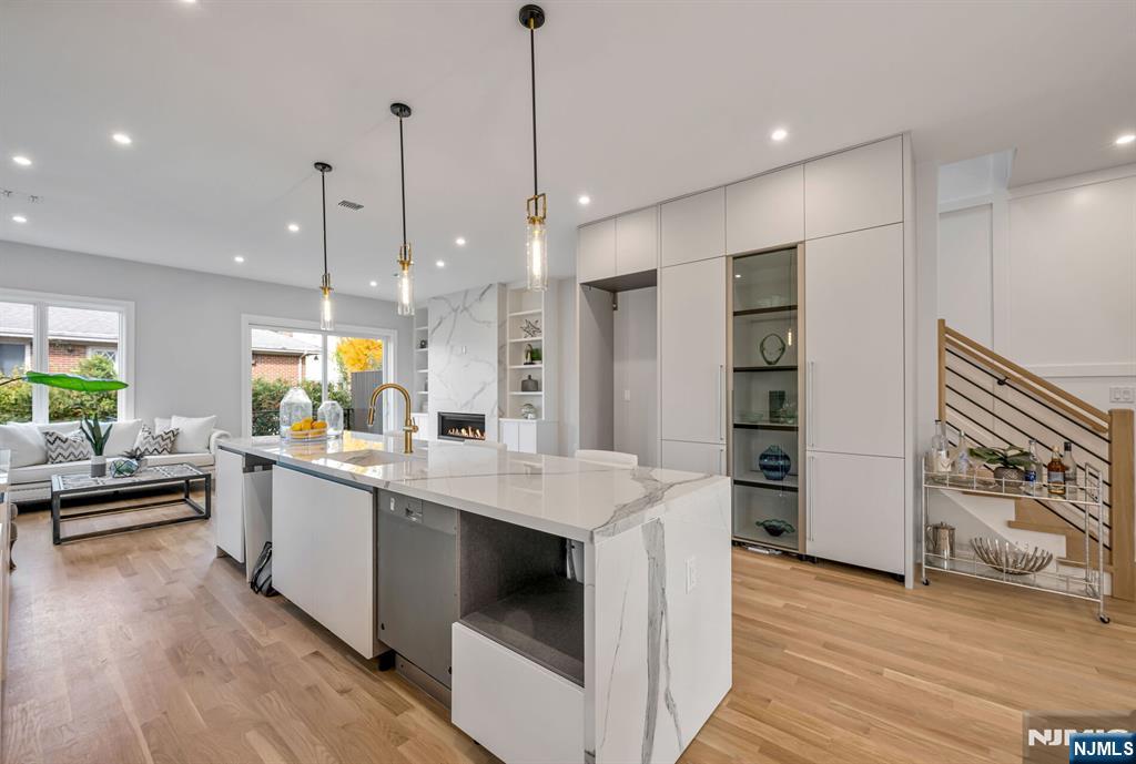 2449 Camner Street Fort Lee, NJ 07024 - Photo 16 of 47 a kitchen with stainless steel appliances kitchen island granite countertop a sink a stove and a wooden floors