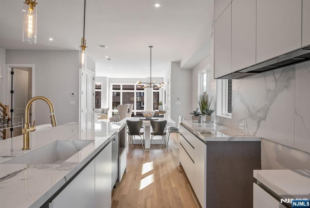 2449 Camner Street Fort Lee, NJ 07024 - Photo 18 of 47 a large kitchen with kitchen island a large counter top space a sink stainless steel appliances and cabinets