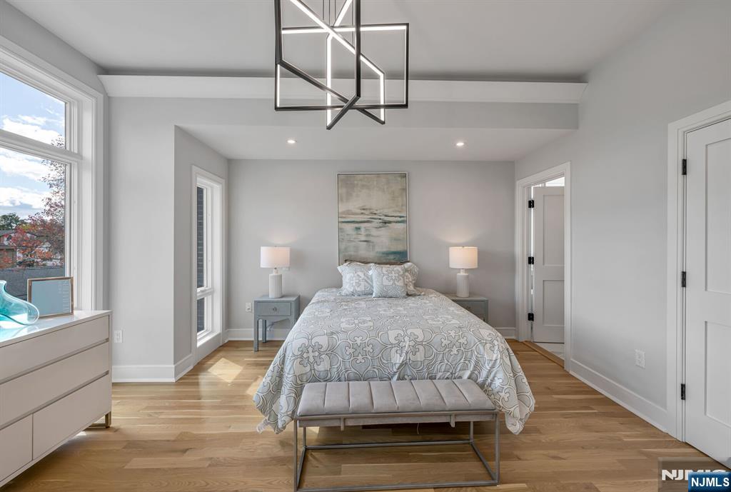 2449 Camner Street Fort Lee, NJ 07024 - Photo 22 of 47 a bedroom with a bed mirror and window