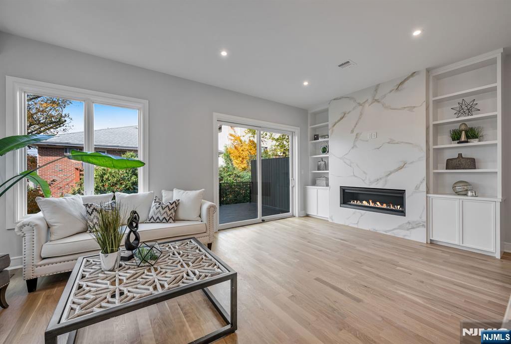 2449 Camner Street Fort Lee, NJ 07024 - Photo 10 of 47 a living room with furniture and a fireplace