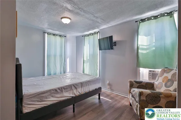 a bedroom with a bed and a television