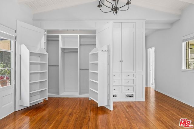 a bathroom with a granite countertop toilet sink and mirror