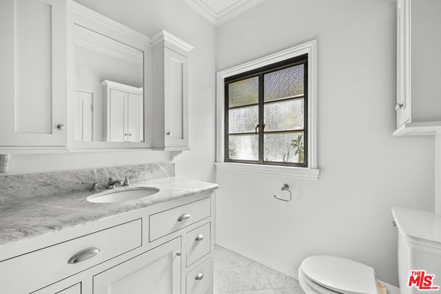 a bathroom with a shower sink and mirror