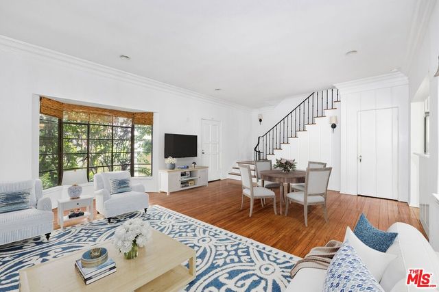 a living room with furniture and floor to ceiling windows