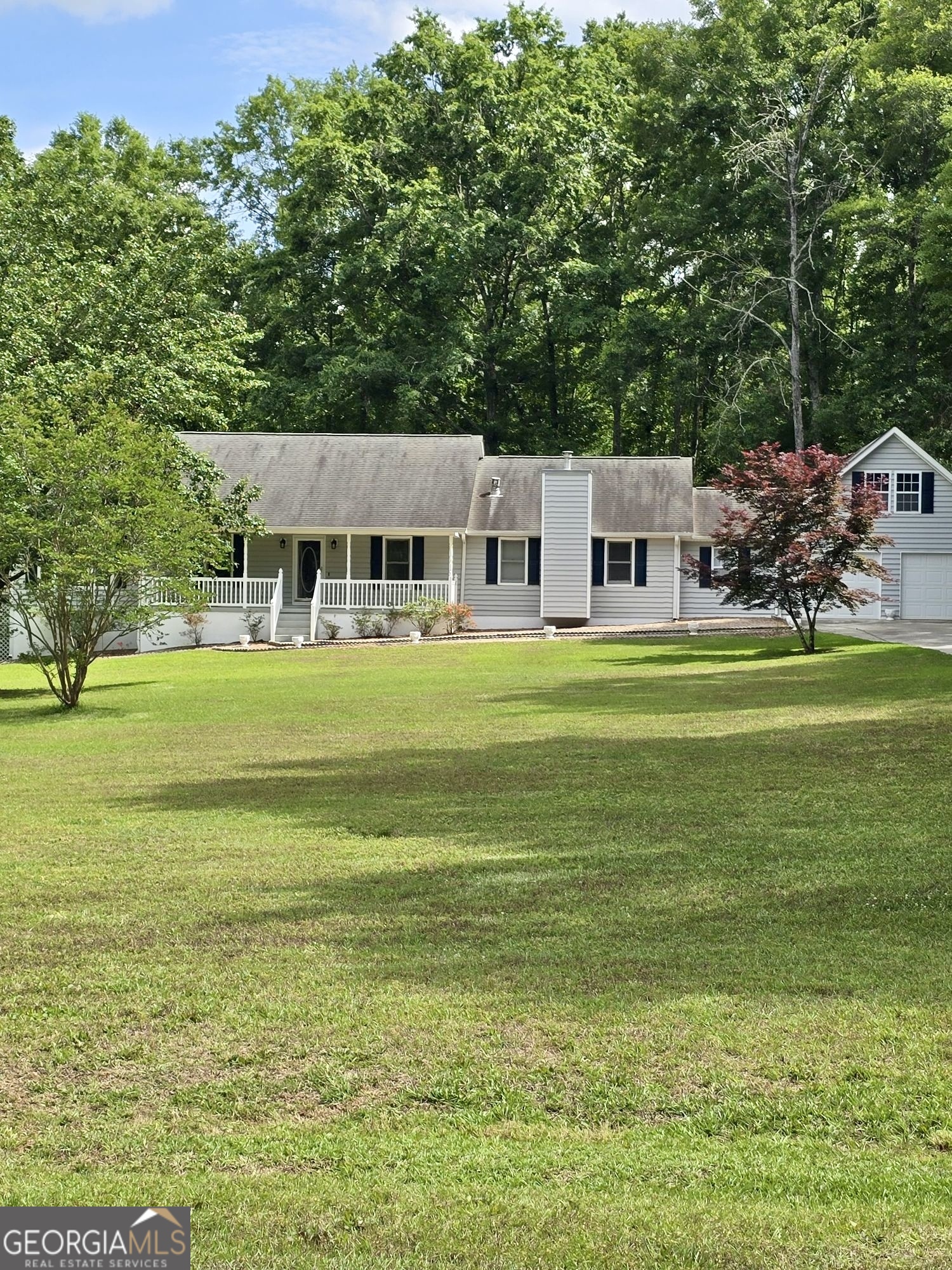 a front view of a house with a garden