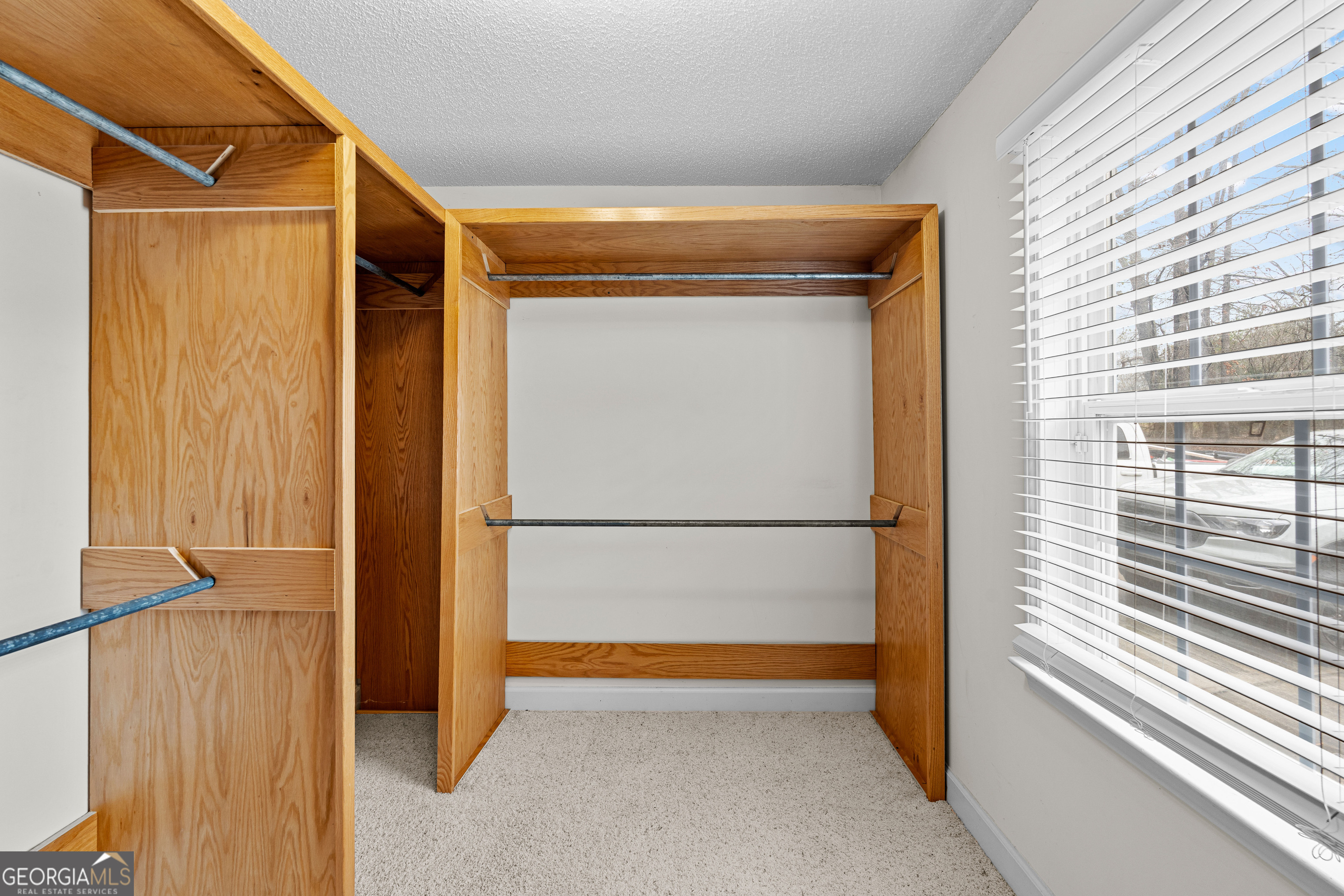 423 Woods Road Brooks, GA 30205 - Photo 32 of 48 a view of walk in closet with clothes
