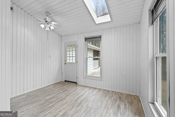 an empty room with closet and chandelier fan