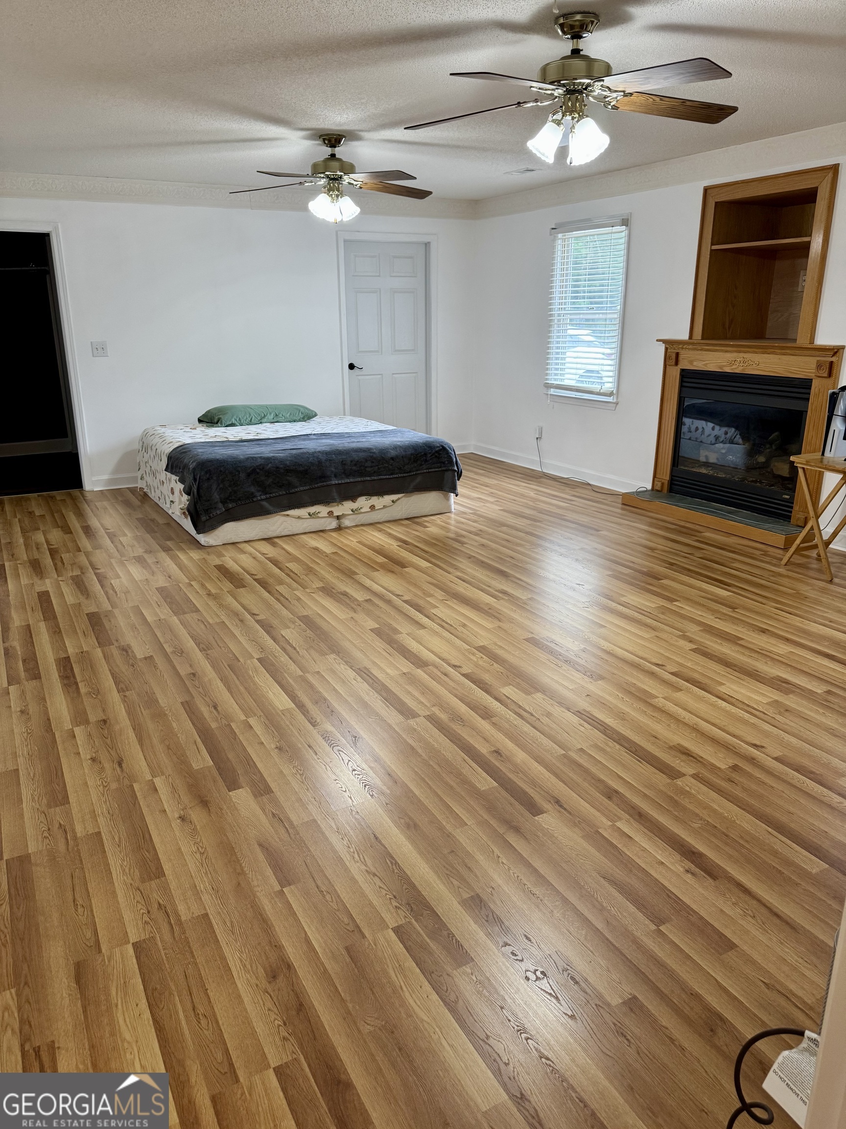 423 Woods Road Brooks, GA 30205 - Photo 48 of 48 a bedroom with a bed and a chandelier