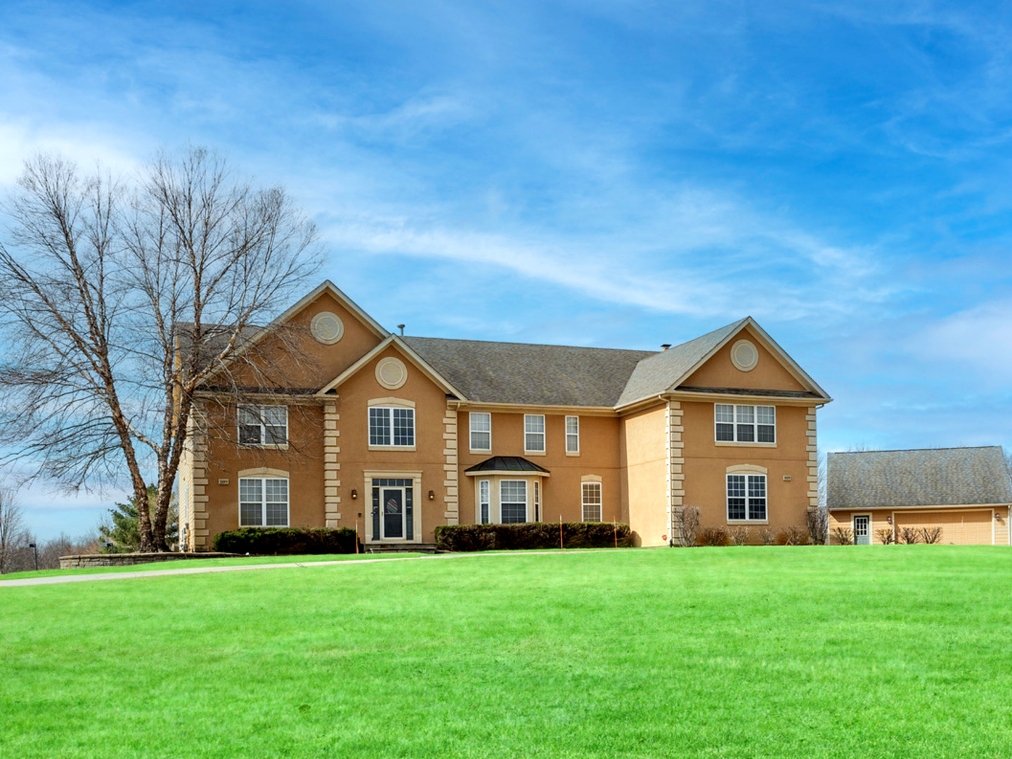 a front view of a house with a garden
