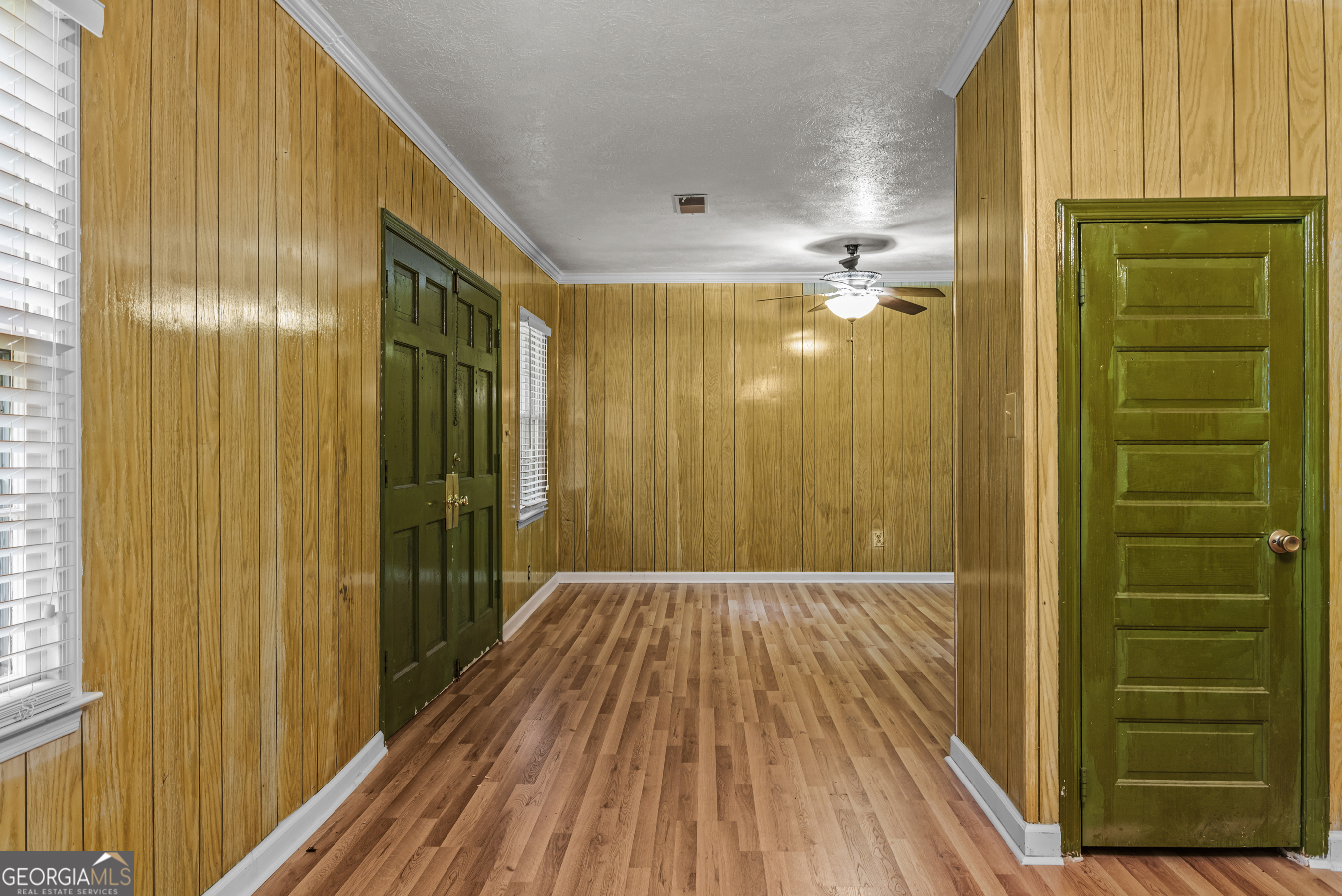 724 Hill Street Madison, GA 30650 - Photo 13 of 36 a view of a hallway with wooden floor and a bathroom