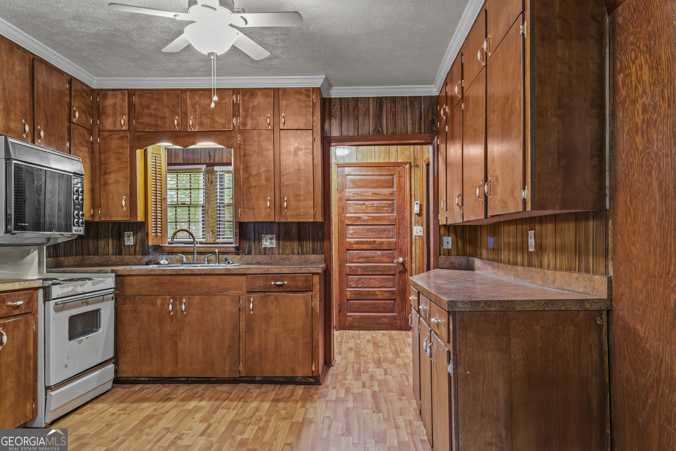 724 Hill Street Madison, GA 30650 - Photo 15 of 36 a kitchen with stainless steel appliances granite countertop a stove a sink and a refrigerator
