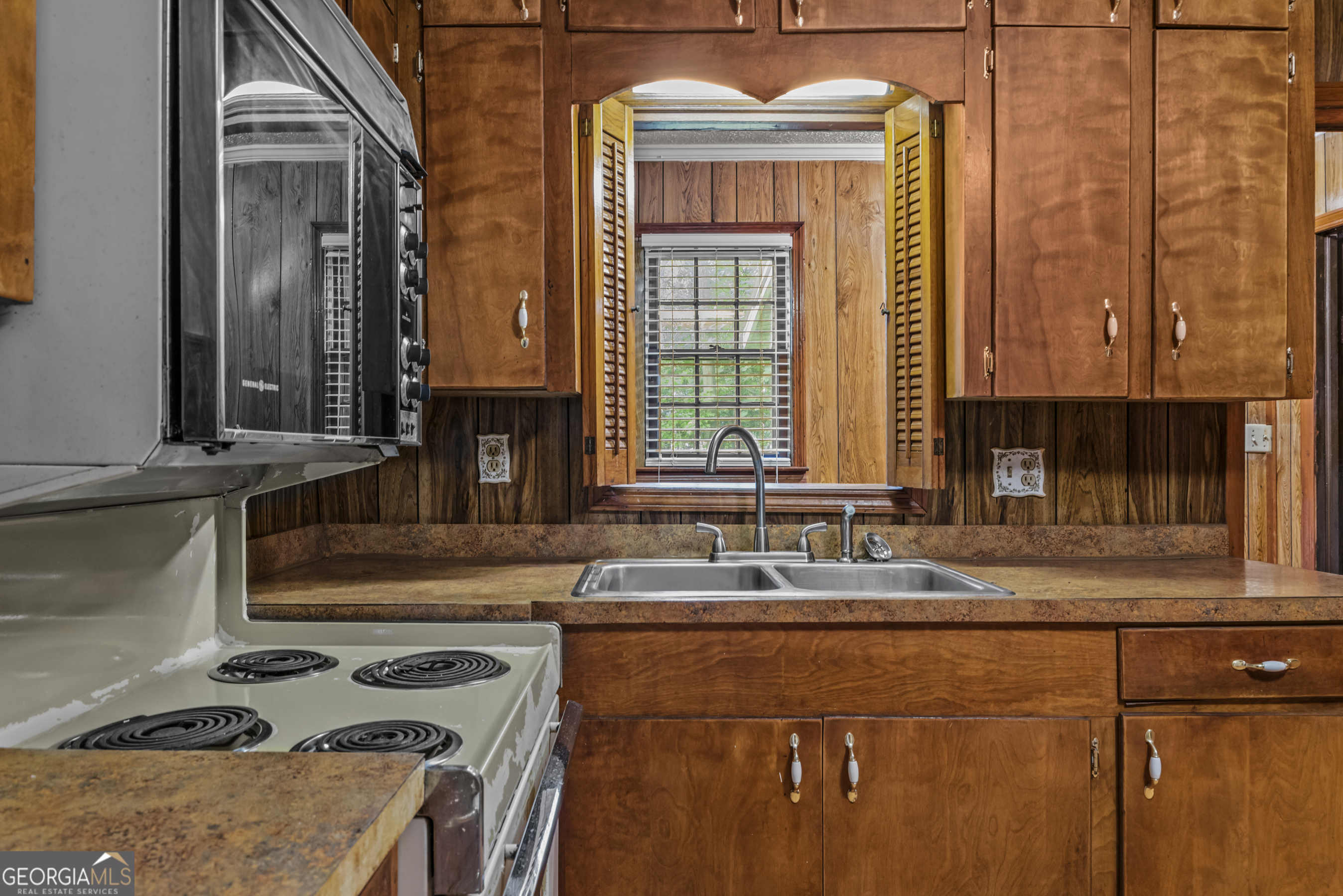 724 Hill Street Madison, GA 30650 - Photo 17 of 36 a kitchen with a stove and a sink