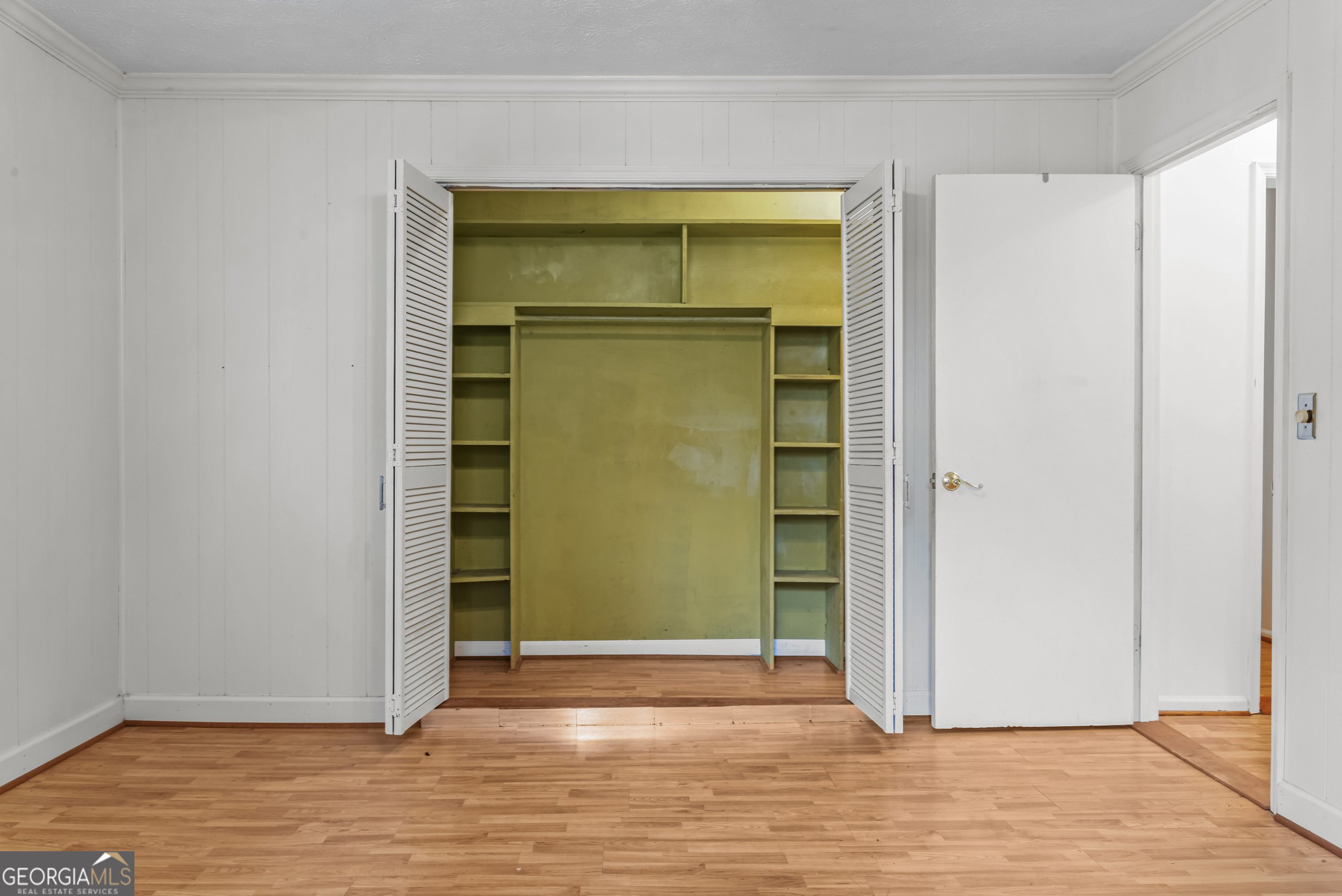 724 Hill Street Madison, GA 30650 - Photo 23 of 36 a view of empty room with wooden floor and door