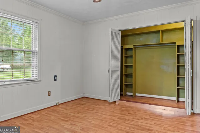 a view of room with window and wooden floor