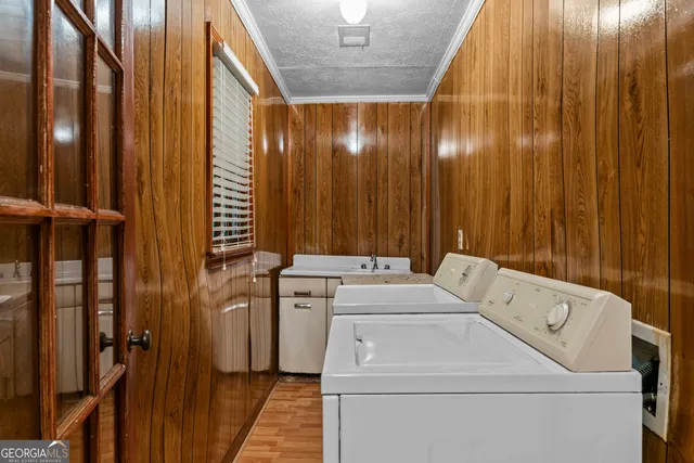 a view of a kitchen with refrigerator and wooden floor