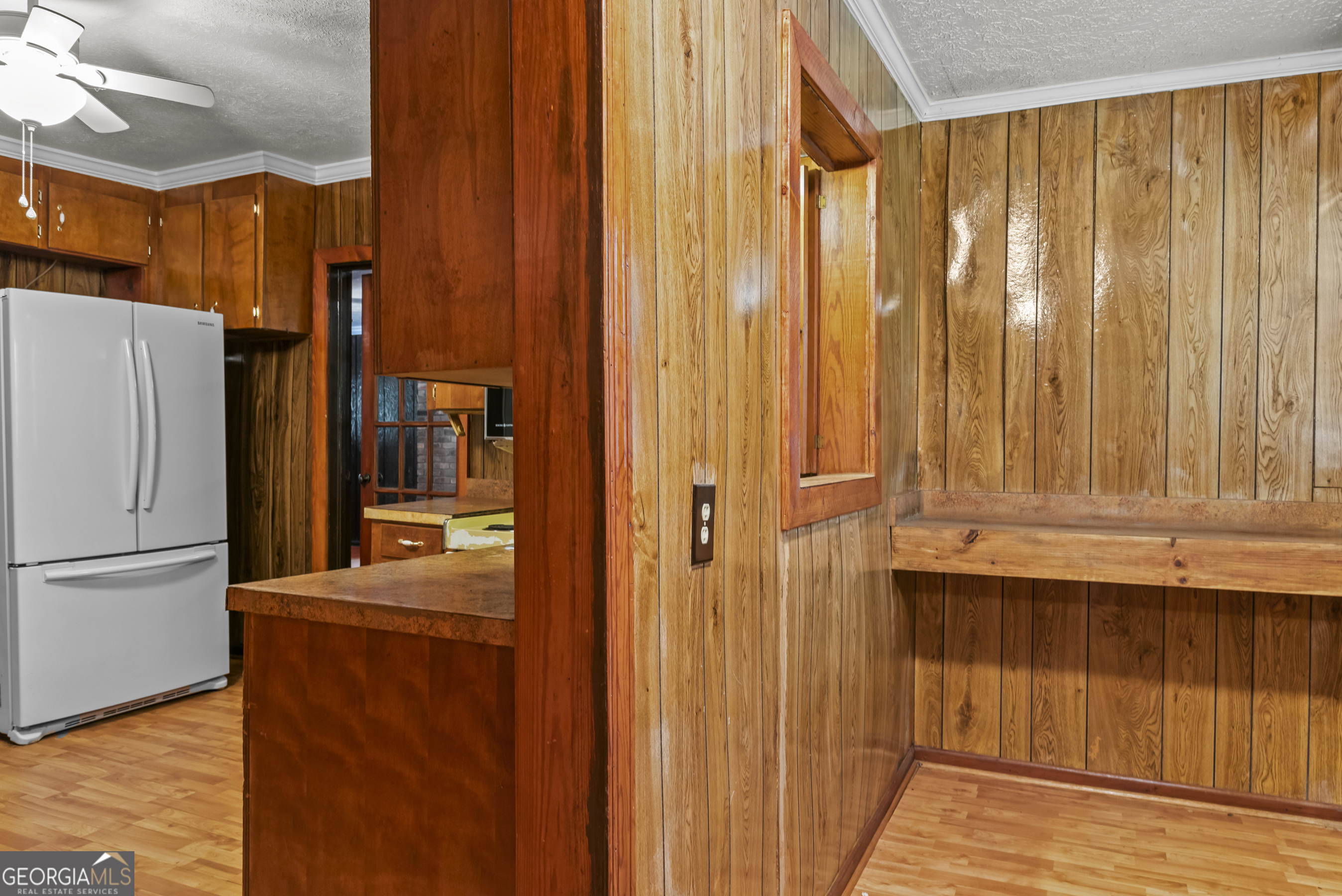 724 Hill Street Madison, GA 30650 - Photo 31 of 36 a view of a kitchen with refrigerator and wooden floor