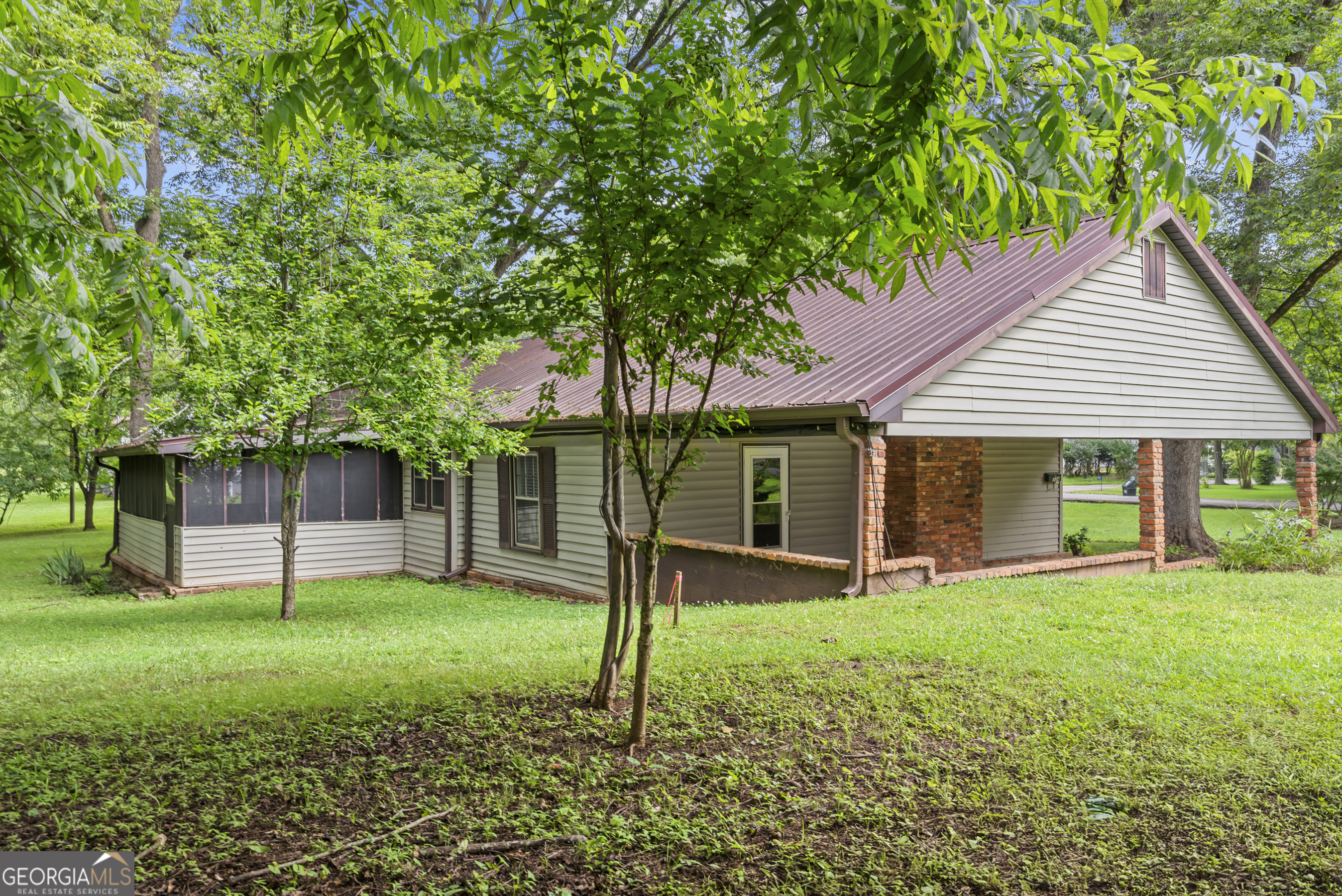 724 Hill Street Madison, GA 30650 - Photo 6 of 36 a view of a house with a yard and sitting area
