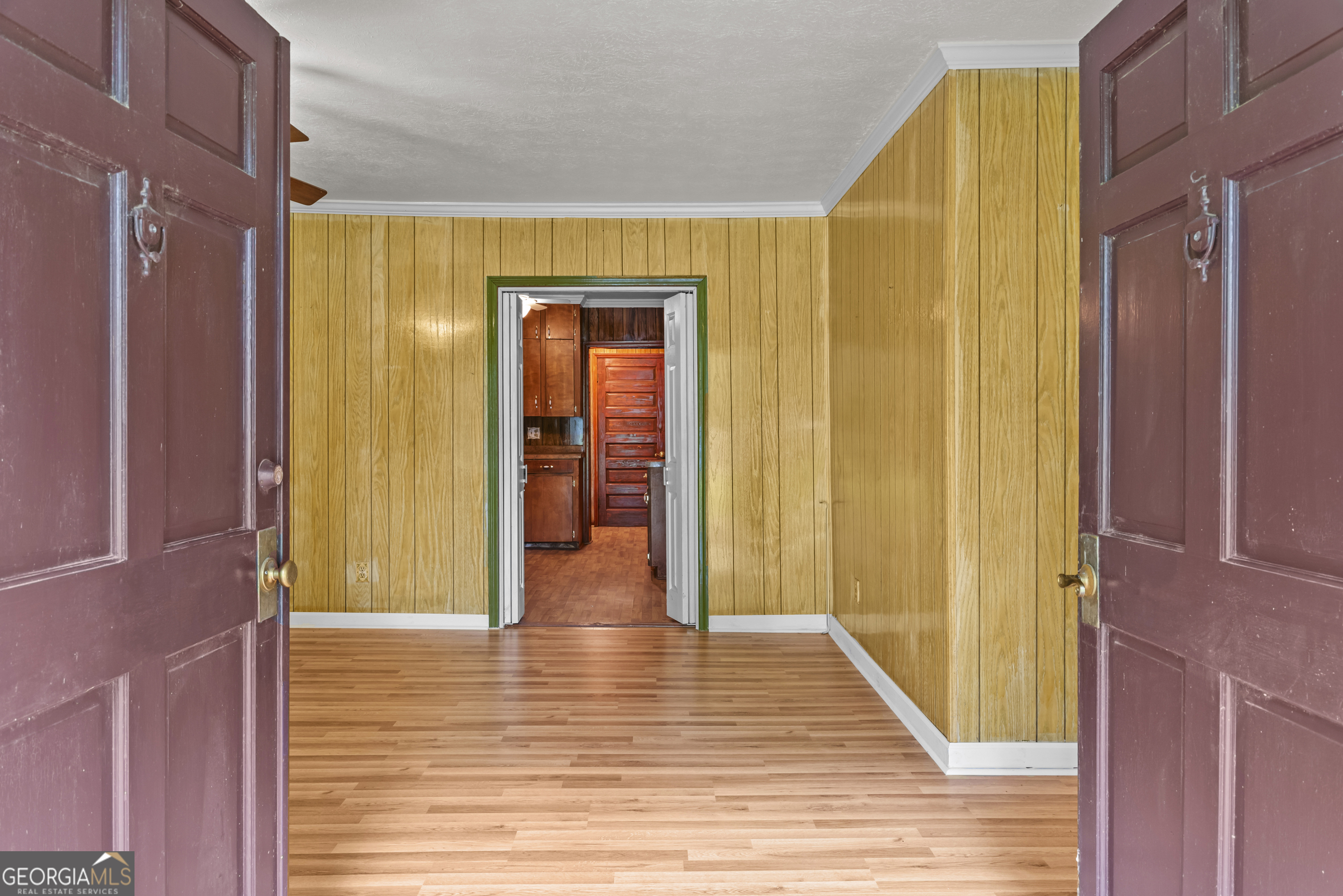 724 Hill Street Madison, GA 30650 - Photo 10 of 36 a view of a hallway with wooden floor and staircase