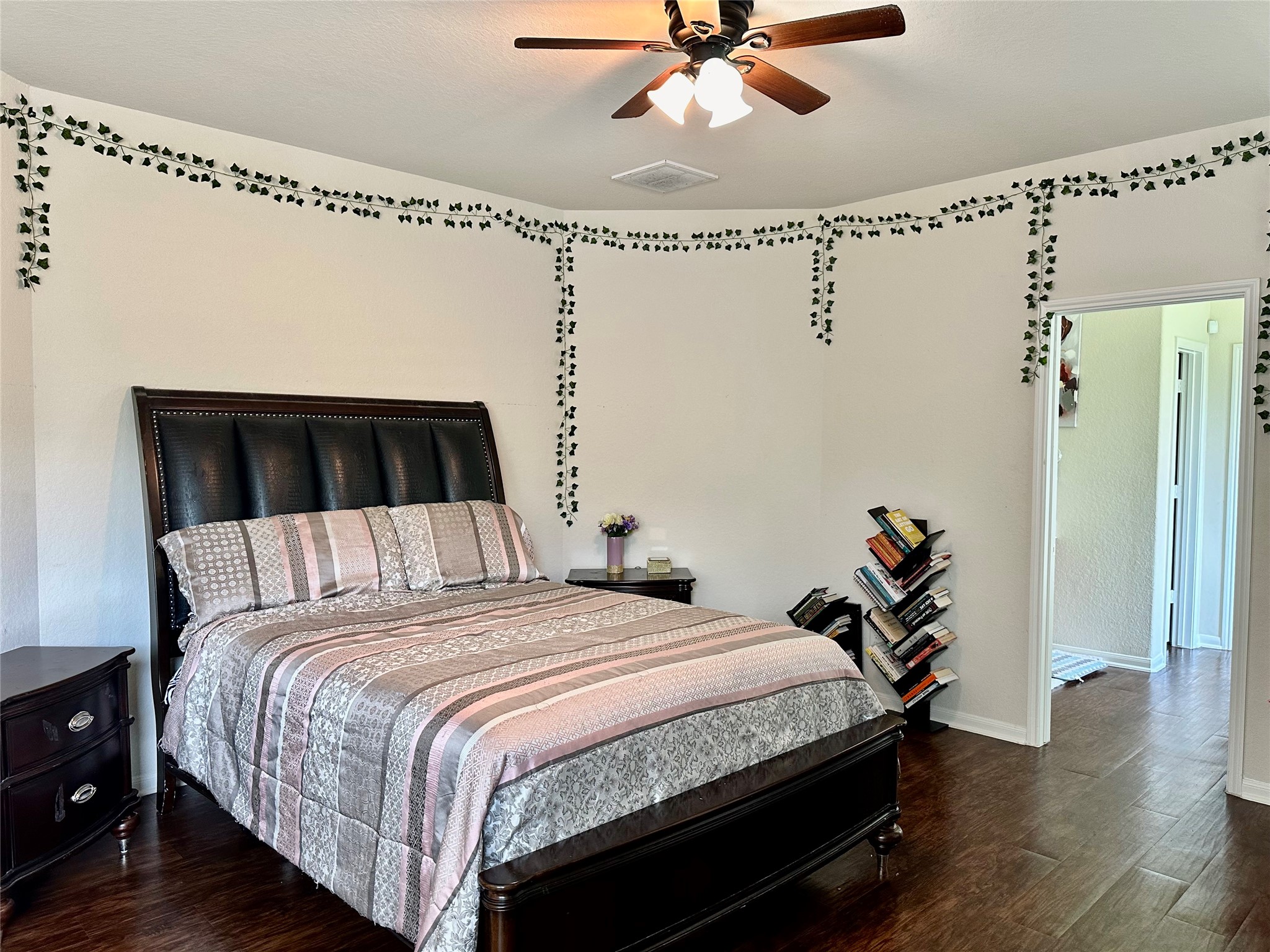 18622 Each Elm Way Houston, TX 77084 - Photo 12 of 35 a bedroom with a bed and wooden floor