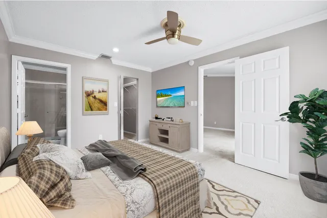 a bedroom with a bed and a potted plant