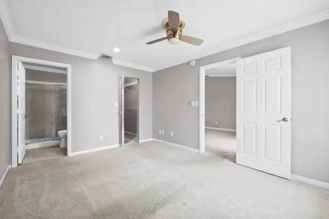 a view of empty room with ceiling fan