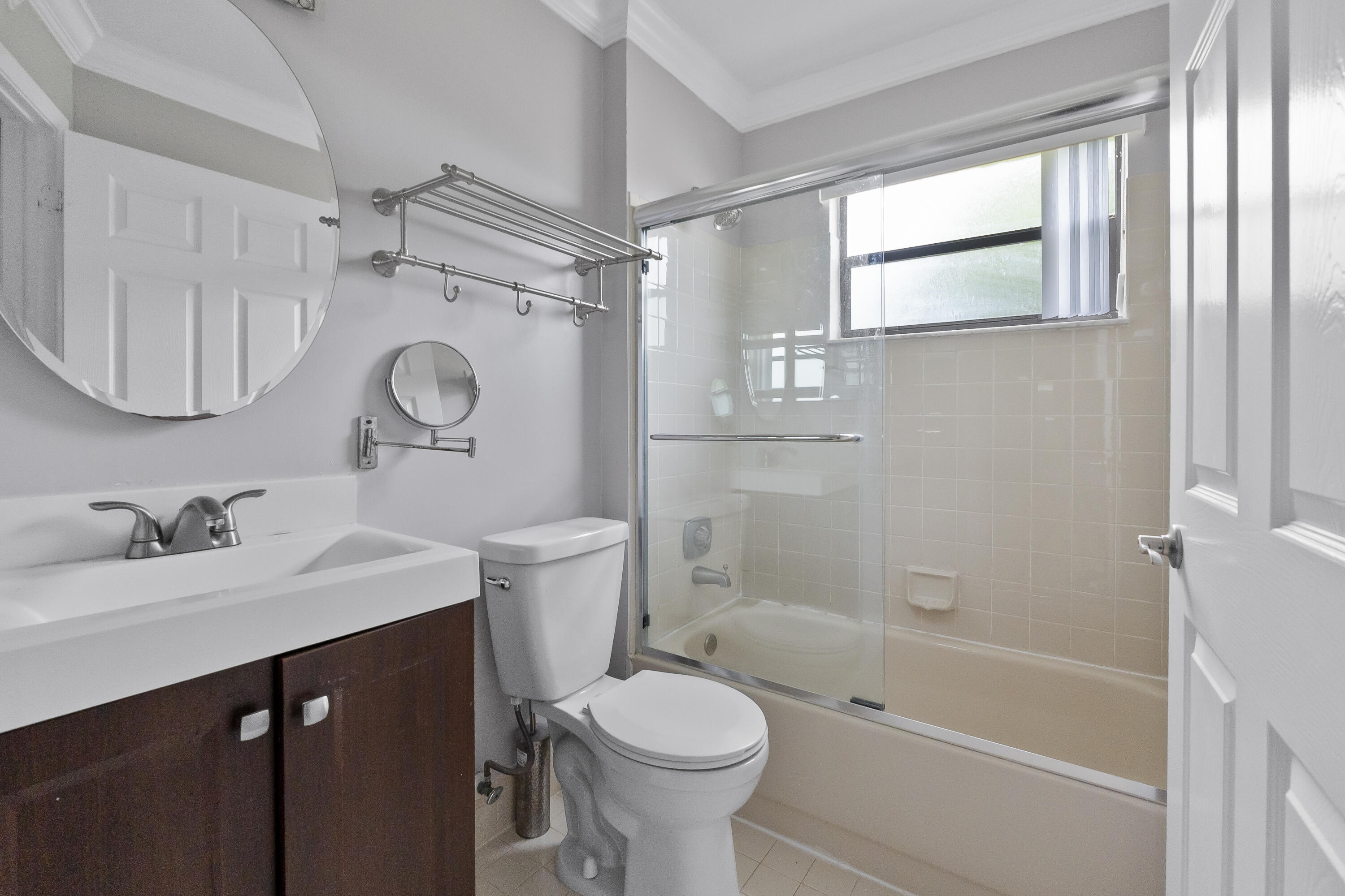 9413 Boca Cove Circle, Unit 1107 Boca Raton, FL 33428 - Photo 17 of 32 a bathroom with a sink toilet and shower
