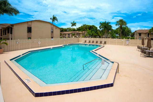 a view of a swimming pool with an outdoor seating