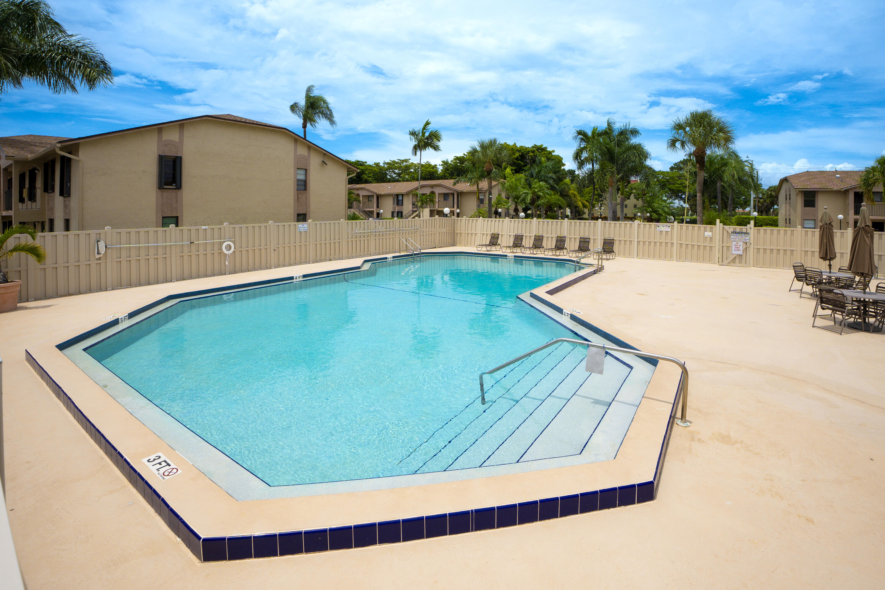 9413 Boca Cove Circle, Unit 1107 Boca Raton, FL 33428 - Photo 21 of 32 a view of a swimming pool with an outdoor seating