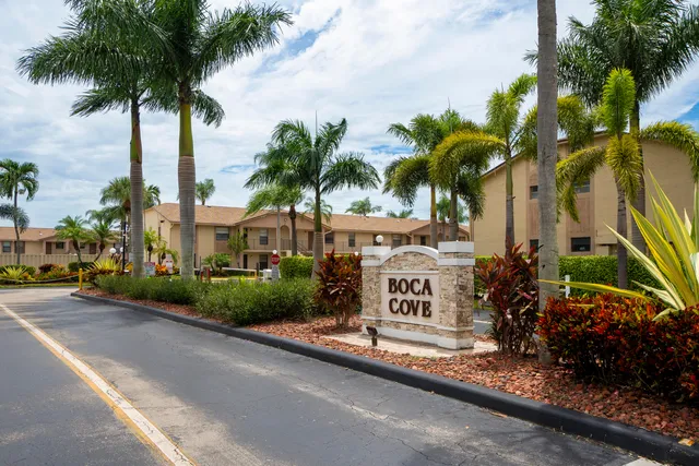a view of multiple houses with palm trees