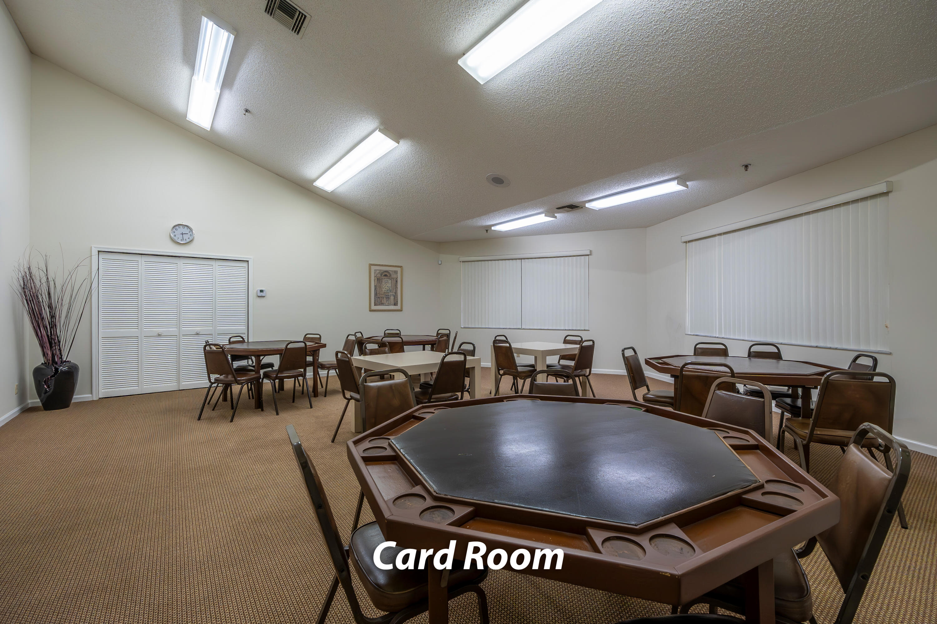 9413 Boca Cove Circle, Unit 1107 Boca Raton, FL 33428 - Photo 27 of 32 a projector room with furniture a table and chairs