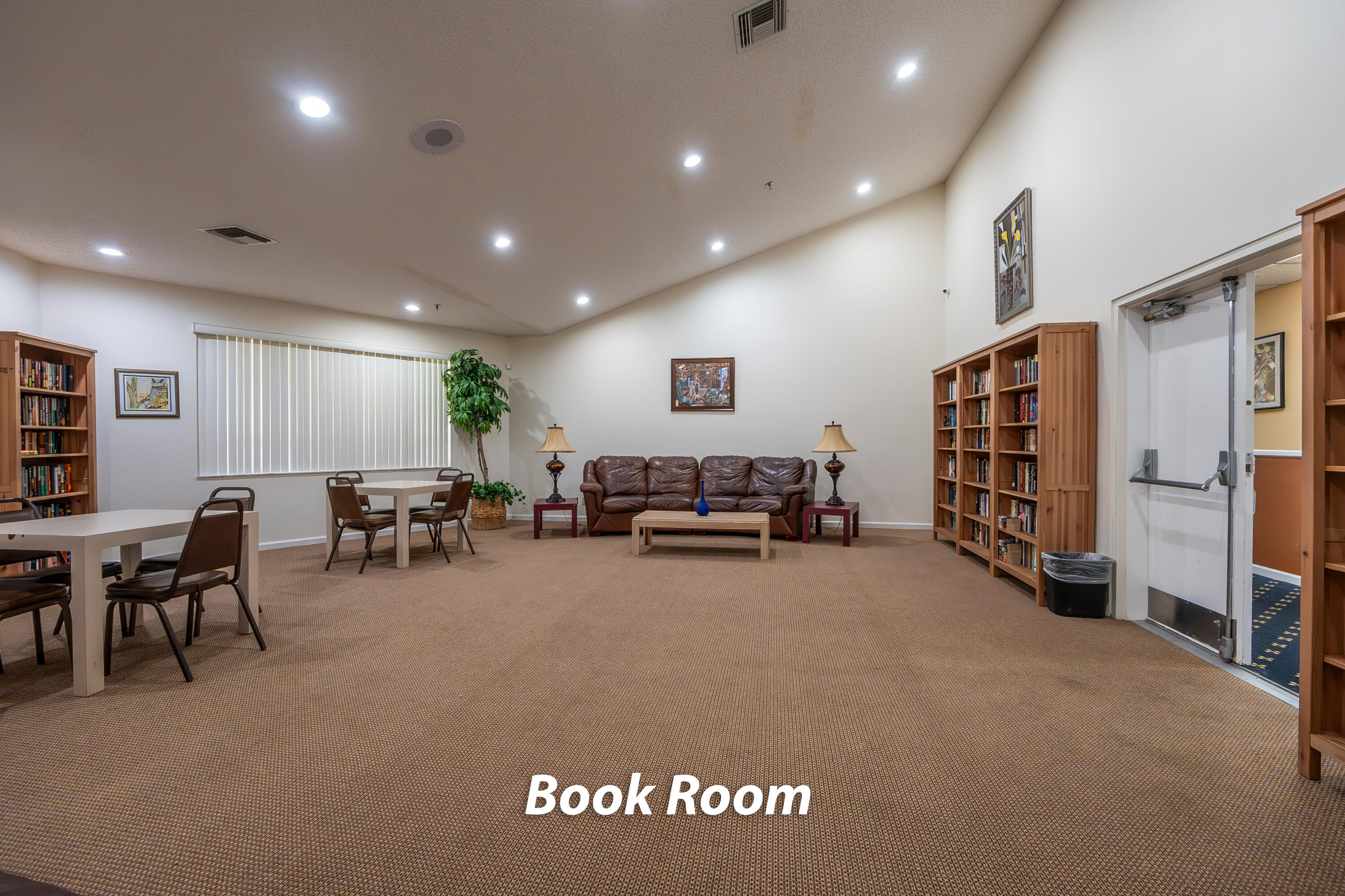 9413 Boca Cove Circle, Unit 1107 Boca Raton, FL 33428 - Photo 28 of 32 a living room with furniture and a flat screen tv