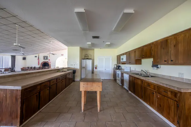 a large kitchen with stainless steel appliances lots of counter space and breakfast area