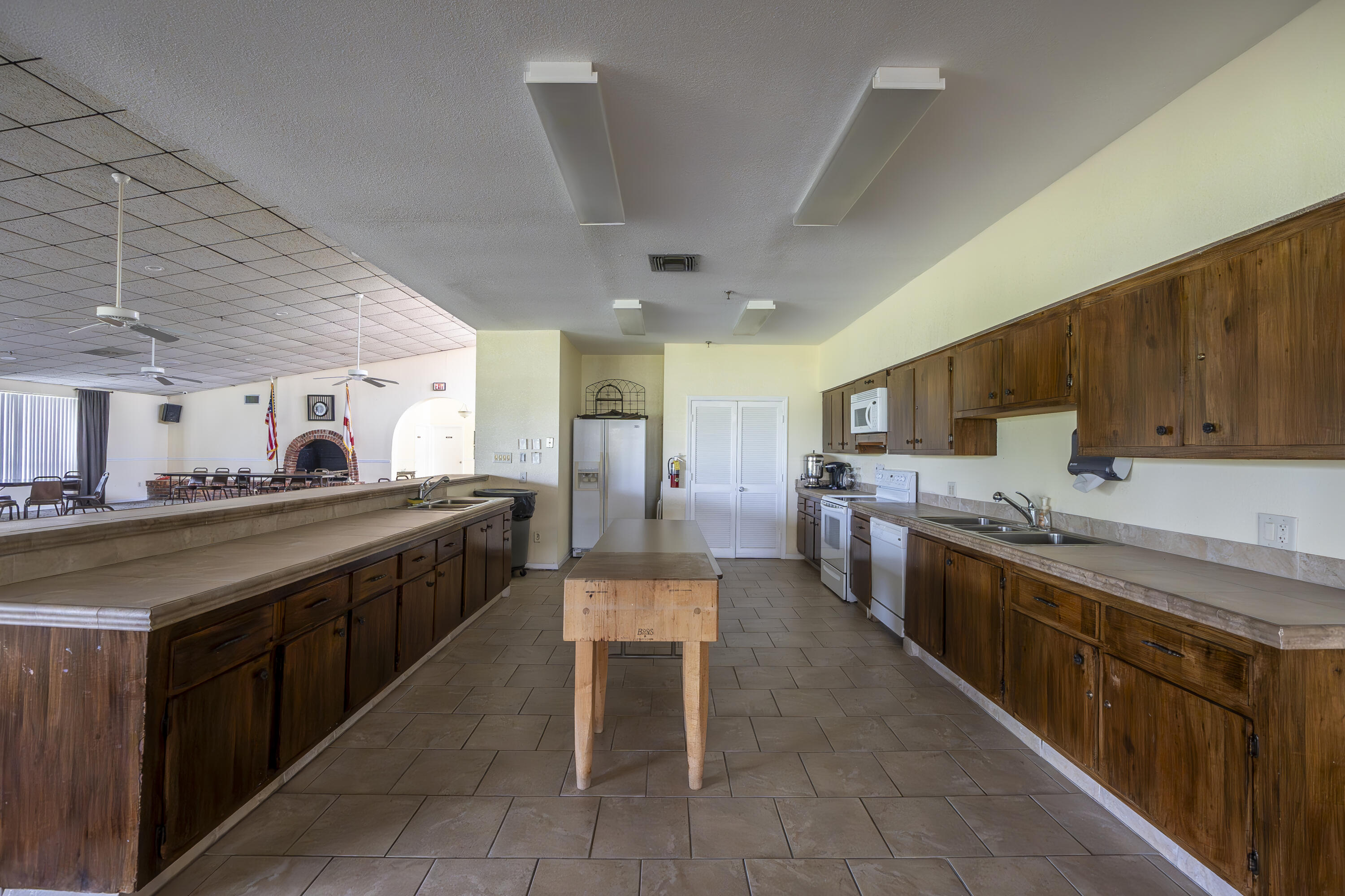 9413 Boca Cove Circle, Unit 1107 Boca Raton, FL 33428 - Photo 30 of 32 a large kitchen with stainless steel appliances lots of counter space and breakfast area