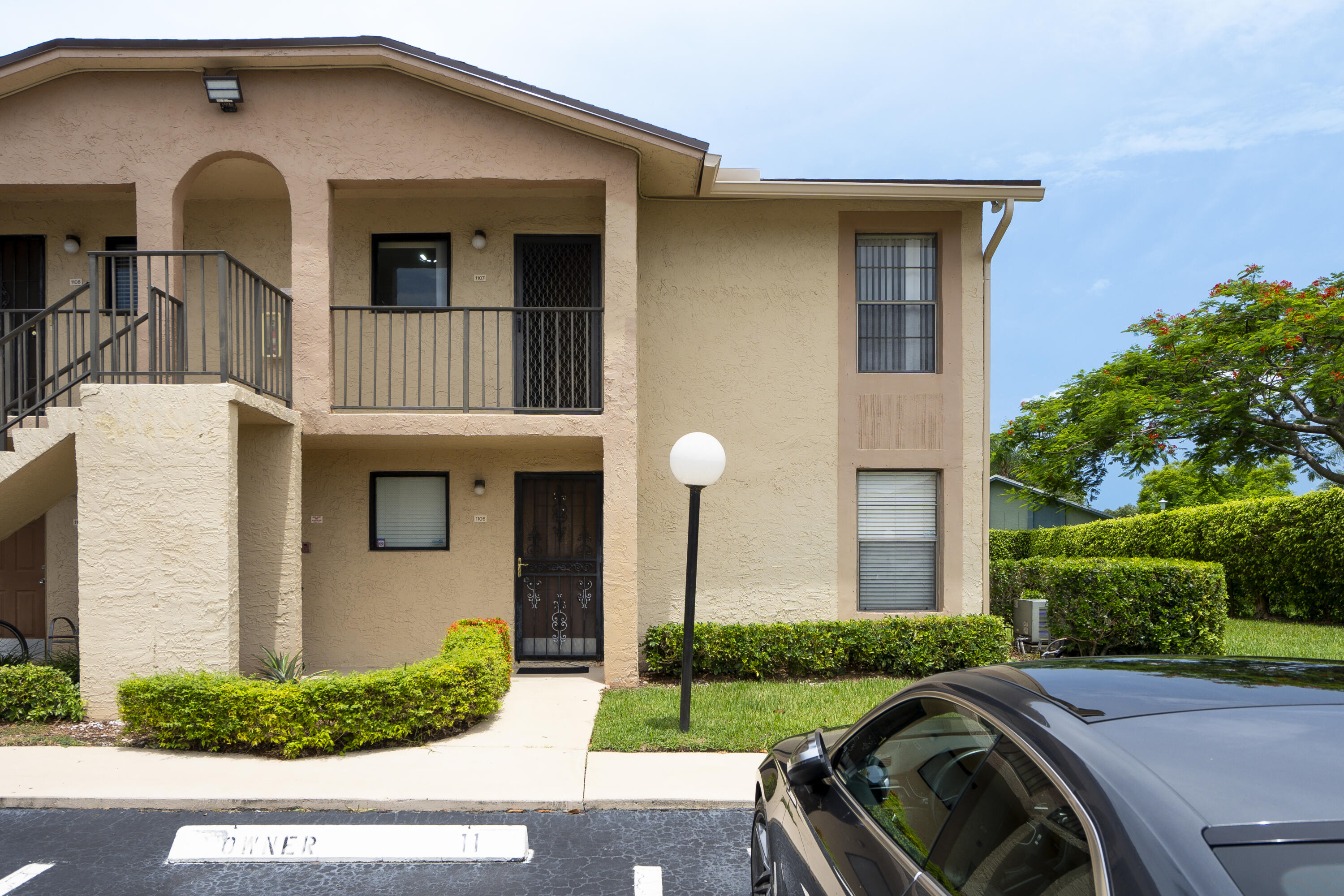 9413 Boca Cove Circle, Unit 1107 Boca Raton, FL 33428 - Photo 4 of 32 a front view of a house with a yard