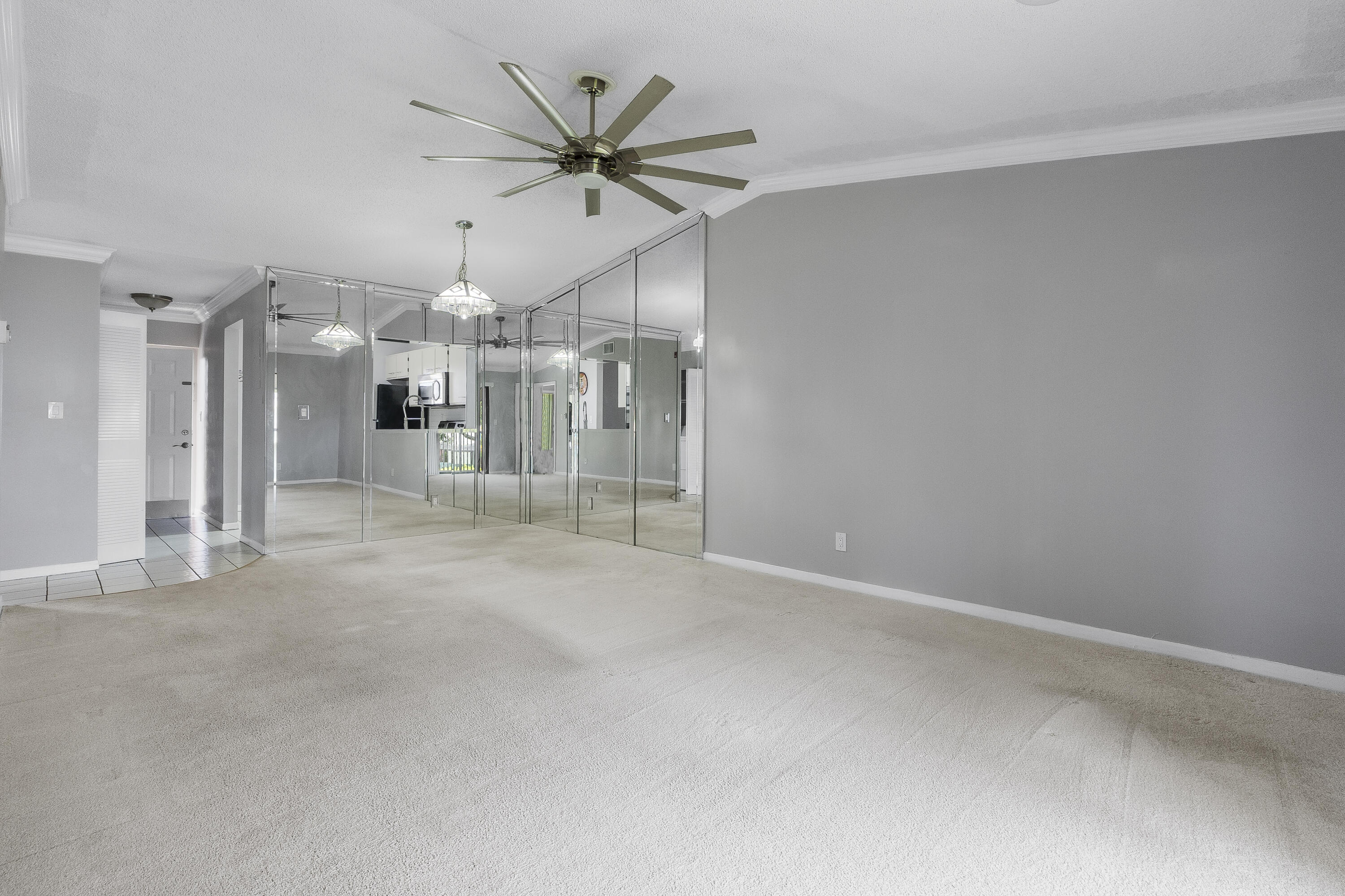 9413 Boca Cove Circle, Unit 1107 Boca Raton, FL 33428 - Photo 7 of 32 a view of a livingroom with a ceiling fan