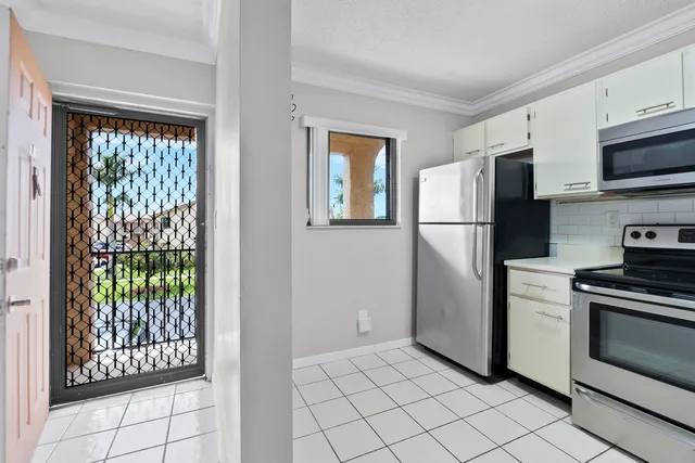 a kitchen with stainless steel appliances granite countertop a refrigerator sink and stove