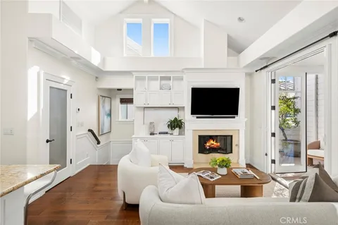 a living room with fireplace furniture and a flat screen tv