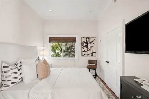 a bedroom with a bed and a flat tv screen