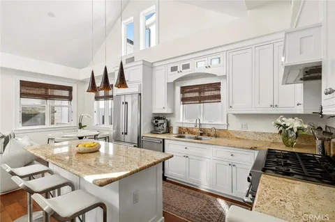 a kitchen with stainless steel appliances granite countertop a sink and cabinets
