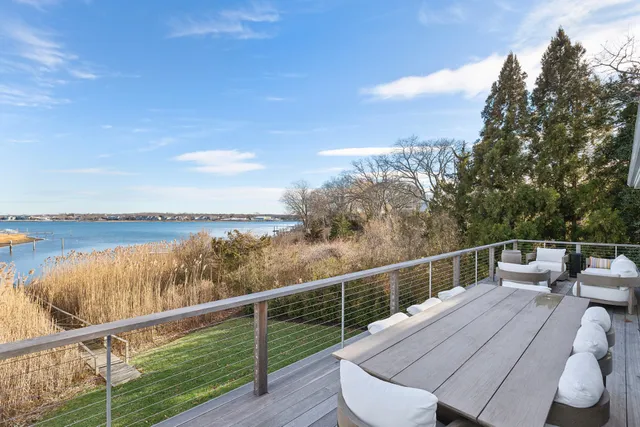 a view of a balcony with wooden floor and lake view
