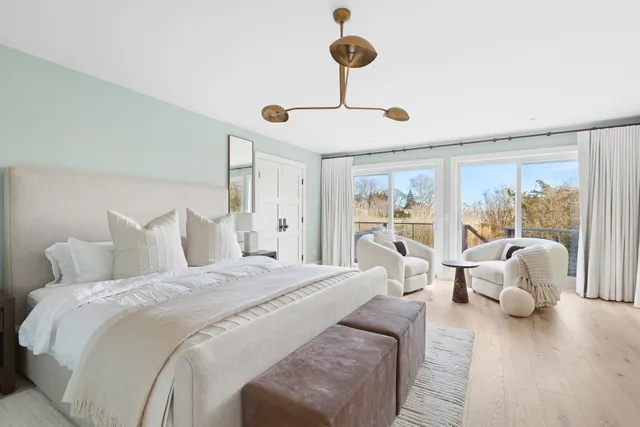 a bed room with a bed and a chandelier