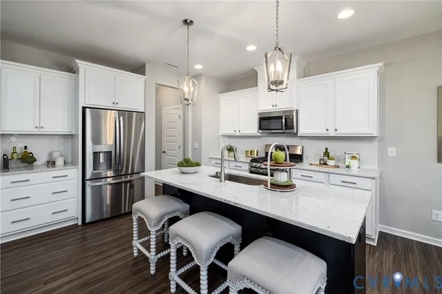 a kitchen with refrigerator cabinets dining table and chairs