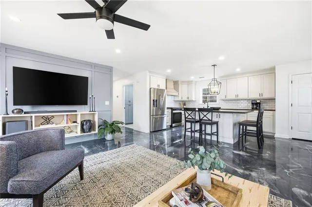 a living room with furniture and a flat screen tv