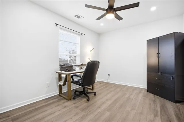 a workspace with wooden floor and a window