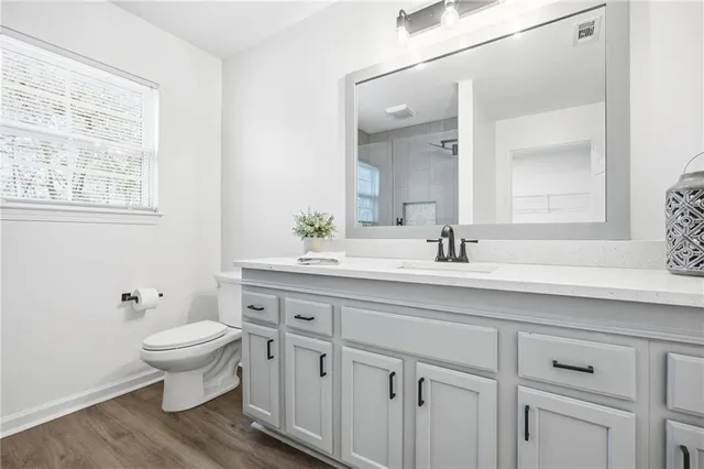 a bathroom with a sink toilet and a mirror