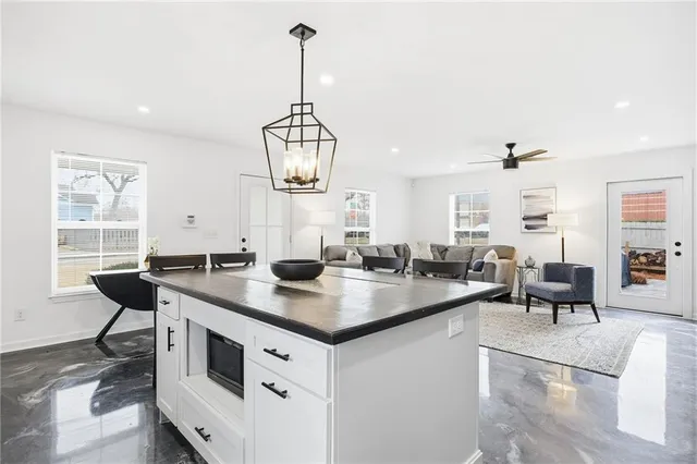 a kitchen with a counter space windows and appliances