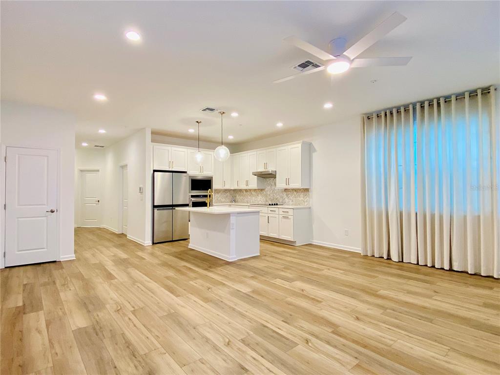 1577 Pinecliff Drive Apopka, FL 32703 - Photo 2 of 37 a large kitchen with stainless steel appliances kitchen island a large counter top and a sink