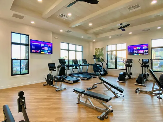 a view of a livingroom with furniture and gym equipment