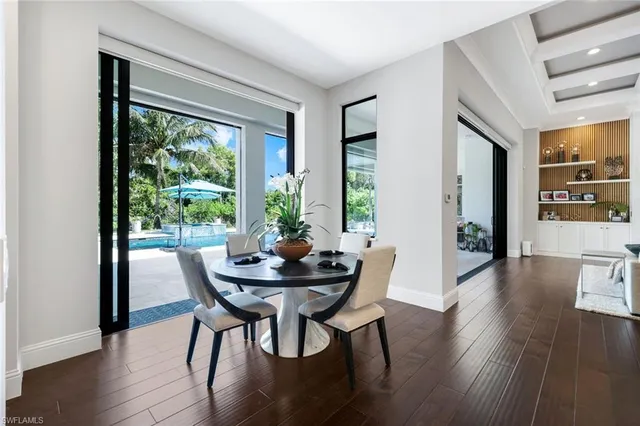 a kitchen with stainless steel appliances granite countertop center island and a wooden floors