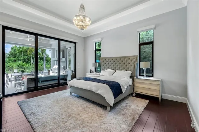 a view of a dining room with furniture wooden floor and chandelier